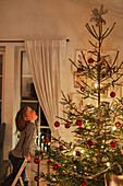 Girl looking at Christmas tree
