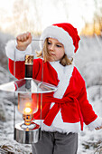 Girl wearing Santa clothes at winter