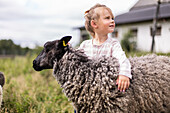 Girl hugging sheep