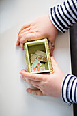Childs hands holding box