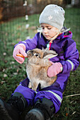 Girl feeding rabbit