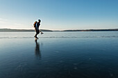 Man ice-skating on frozen lake