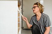 Woman painting cupboard