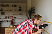 Woman with electric drill
