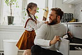 Father and daughter in kitchen