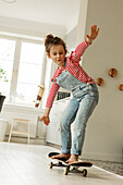 Girl skateboarding at home