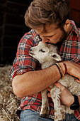 Farmer holding lamb