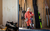 Girl holding skis