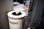 Man putting paper in bin