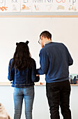 Student and teacher in front of whiteboard