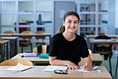 Teenage girl sitting in classroom