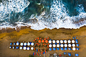 Aerial view of beach umbrellas and sea