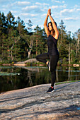 Woman at lake doing yoga