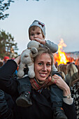 Mother carrying daughter on shoulders