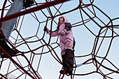 Girl on climbing frame