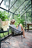 Woman using tablet in greenhouse
