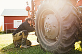 Woman repairing tractor