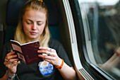 Woman holding passport in train