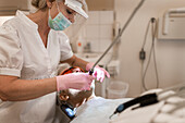 Dentist examining patients teeth