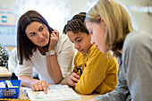 Teacher helping children in classroom