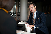 Smiling businessman talking in restaurant