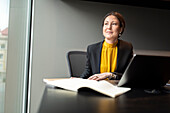 Businesswoman in office looking away