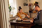 Father and daughter playing board game