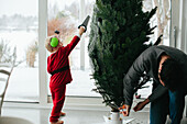 Father and toddler preparing Christmas tree