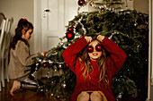 Girl in front of Christmas tree