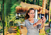 Woman photographing with cell phone