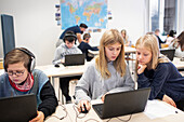 Children in classroom using laptops