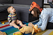 Mother playing with baby at home