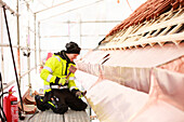 Woman working on roof