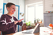 Woman having sign language conversation via video call on computer