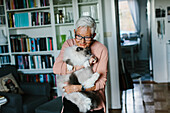 Senior woman holding cat