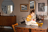 Girl on table writing in notebook