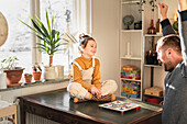 Father and daughter playing board game