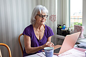 Senior woman using laptop