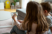 Children video chatting via cell phone