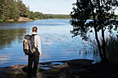 Hiker standing at lake