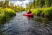 Woman kayaking on river
