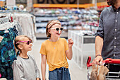 Smiling girls trying sunglasses in shop