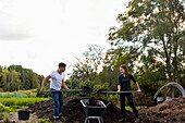Young couple digging in garden