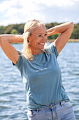 Happy woman standing at water