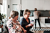 Senior women talking at home