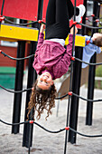 Girl playing on climbing frame