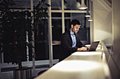 Man working with laptop in public space