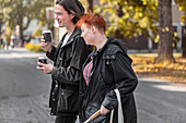 Sehbehinderte Frau geht mit männlichem Freund auf der Straße