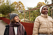 Two young women walking in park