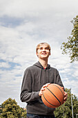 Teenage boy holding basketball